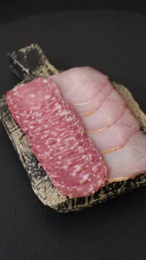 Slices of Salami and Ham on Cutting Board