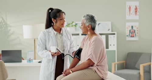 Clinic, doctor and talking with woman, blood pressure and healthcare, service and consultation