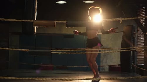 Athletic Woman Jump Roping in Boxing Ring