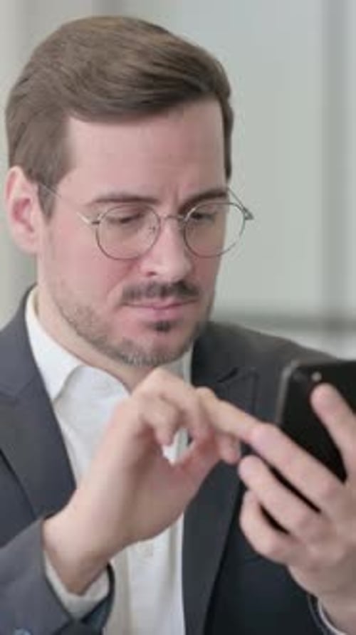 Frustrated Man Using Phone Inside