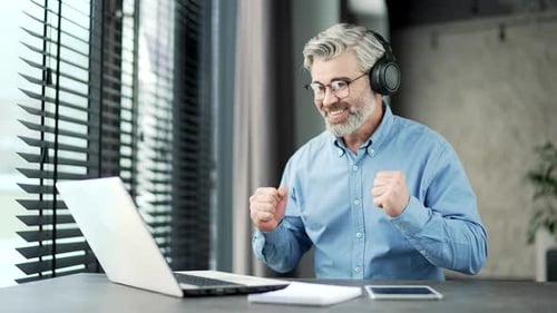 Excited Man Celebrating Success in Home Office