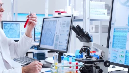 Scientist Examining Test Tube in Bright Laboratory