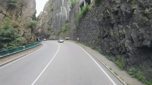 Scenic Drive on Mountain Road with Green Vegetation