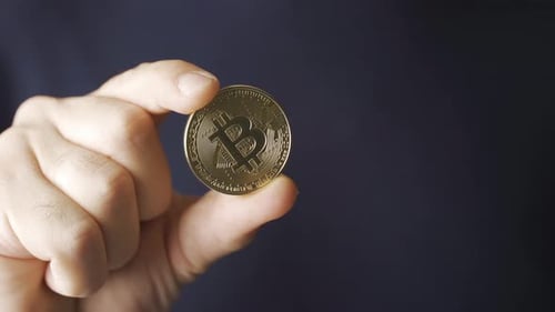 Hand Holding Golden Bitcoin Crypto Currency