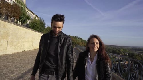 Couple walking together with wind