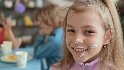Girl Smiling with Cream on Her Face