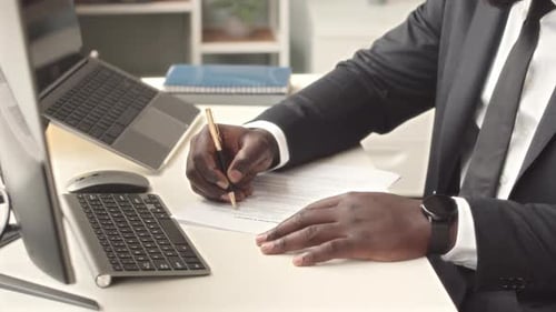 Professional Man Signs Contract and Types on Computer