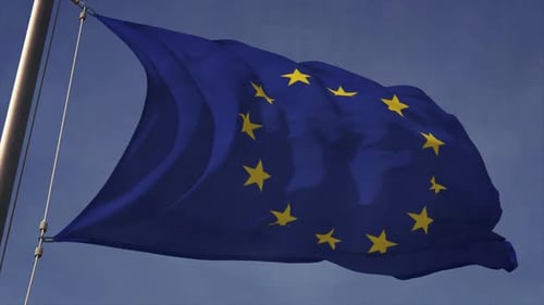 Waving European Union Flag Against Blue Sky Background