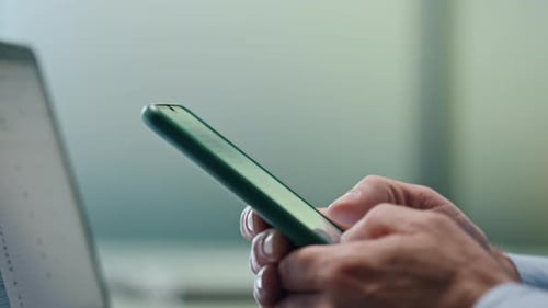 Manager Texting on Mobile Device at Office