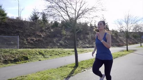 Active Woman Jogging on Park Path