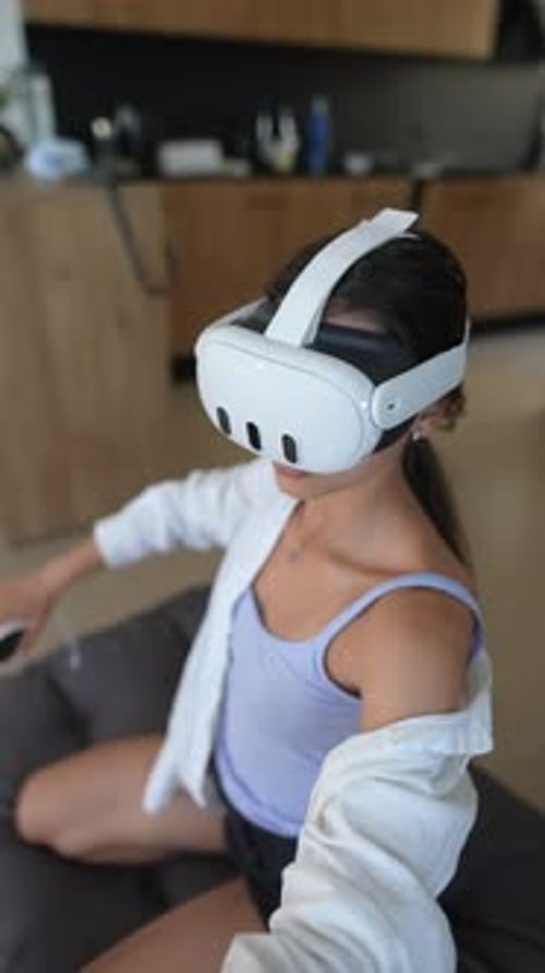Woman Experiencing Virtual Reality with Headset and Controllers