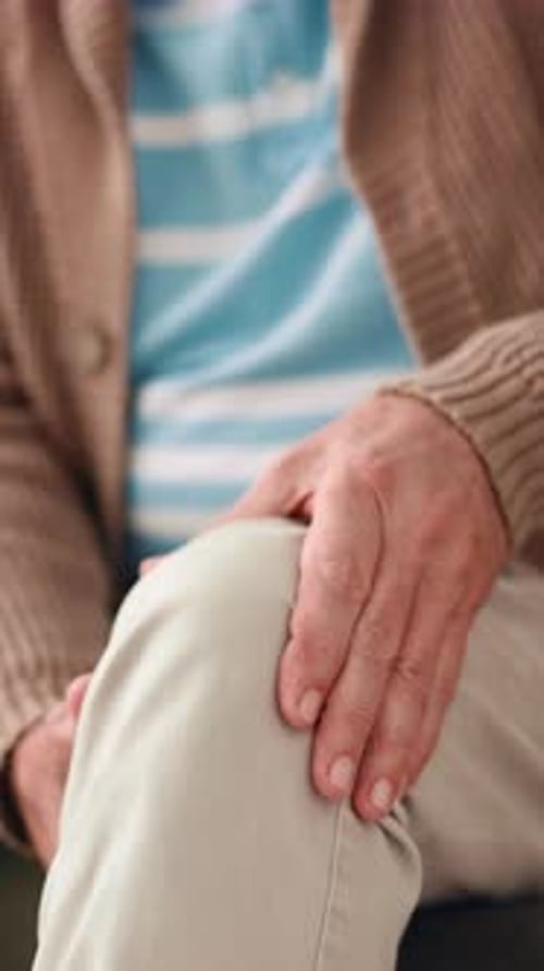 Person Touching Knee In A Seated Position