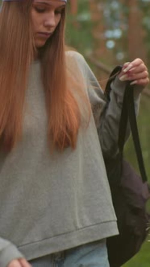 Siblings Hiking Through Serene Forest Preparing for a Rest