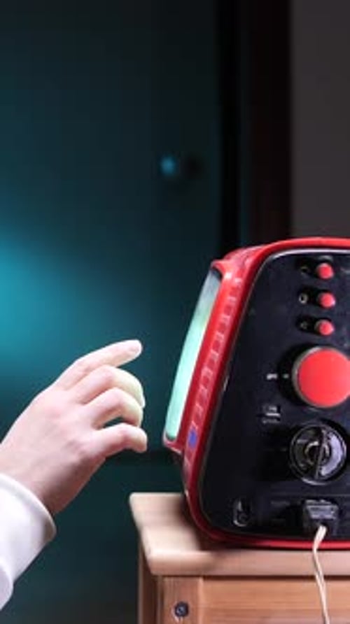 Hand Touching Vintage Television Set Turquoise Screen