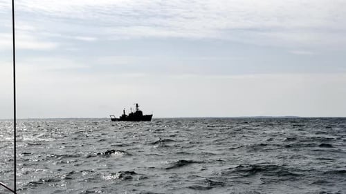 Naval Vessel Patrols the Waters, a Symbol of Security and Defense Against a Backdrop of Gray