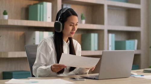 Asian Chinese Woman Office Worker in Headphones Laptop Video Call Discuss Report Female Girl