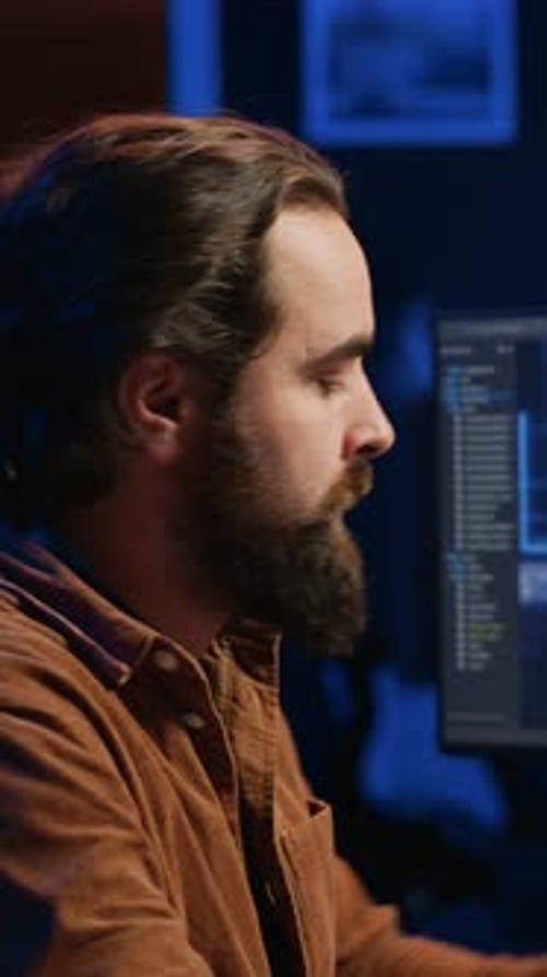 Man with Beard Works Late at Computer