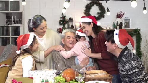 Family Christmas Gathering Celebrates with Hugs