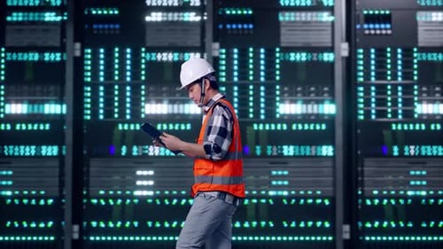 Asian Male Use Tablet While Walking in Data Center