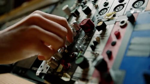 Sound engineer using digital audio mixer sliders Engineer pressing keys adds control panel volume