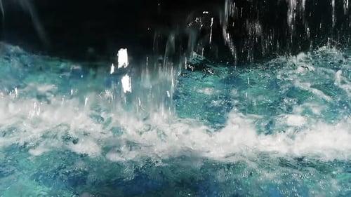 Close-up of water pouring out of a water fountain in slow motion at 96fps.