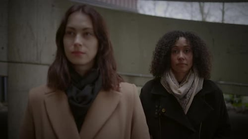 Lifestyle Portrait of Two Young Women Watching Tower Building Together
