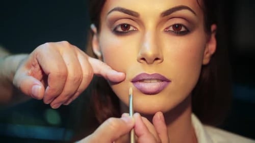 Closeup profissional de maquiagem de batom de mulher aplicando batom vermelho nos lábios Beleza e maquiagem