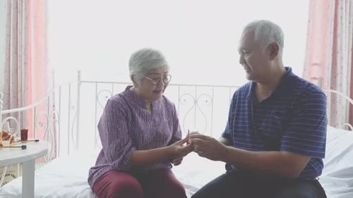 Senior Couple Taking Medication Together at Home