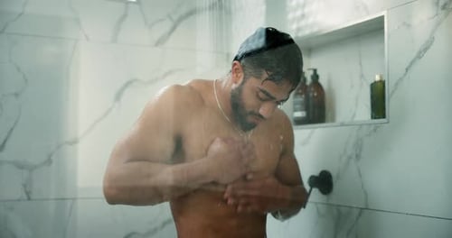 Muscular Man Cleans Chest with Soap in Shower