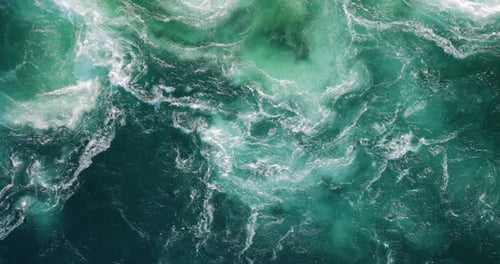 Blue waves of water of the river and the sea meet each other during high tide and low tide.