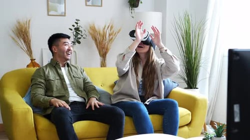 Couple Experiences Virtual Reality on Couch