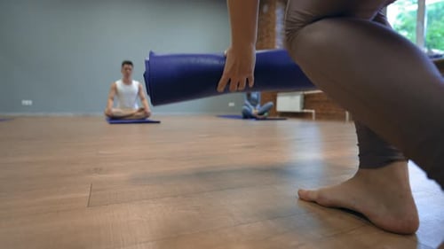 Yoga Class Preparing for Meditation in Bright Studio