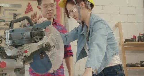 Woman Cuts Wood with a Power Saw