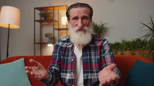 Senior Man Talking and Gesturing Indoors