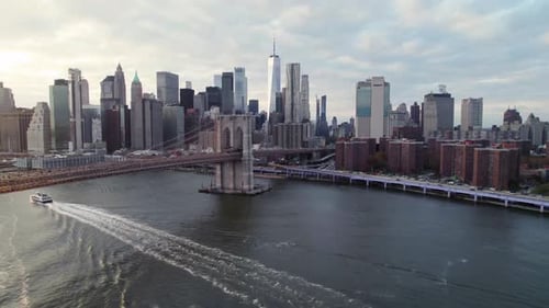 Downtown New York City with the Brooklyn Bridge and a passing ferry