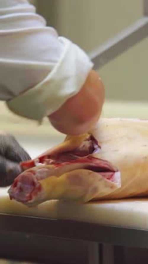 Butcher Singeing and Chopping Cut of Meat