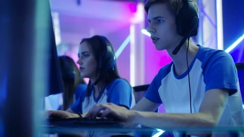 Young Adults Playing Computer Games in Futuristic Room