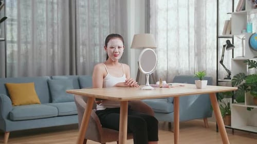 Woman Applying Facial Mask at Home