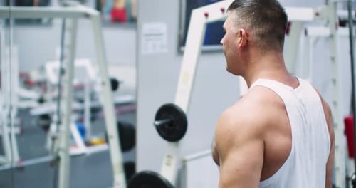 Slow Motion Cropped Footage of a Caucasian Man During Gym Workout in Front of the Mirror