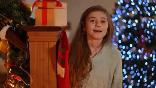 Smiling Girl Near Christmas Tree at Night