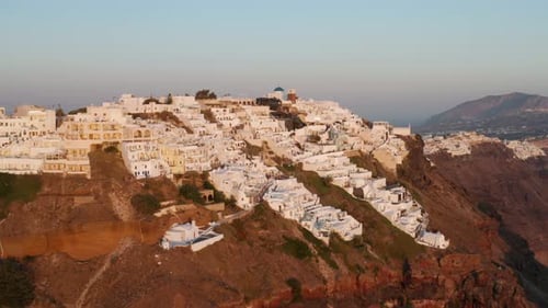Mountainside Town Of Imerovigli During Sunset In Santorini Island, Greece. Aerial Shot