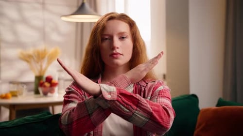 Young Woman Expressing Refusal With Arms Crossed