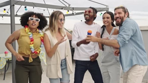 Friends Dancing and Singing on Urban Rooftop Party