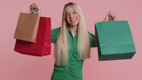 Happy Woman With Shopping Bags Against Pink Background