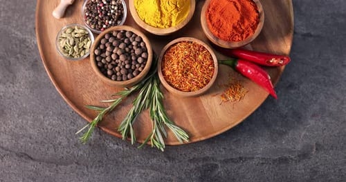 Different aromatic spices on grey table, top view