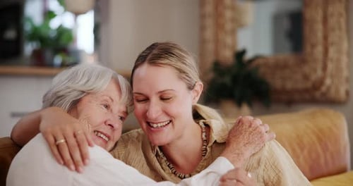 Smiling Women Share a Warm Embrace at Home
