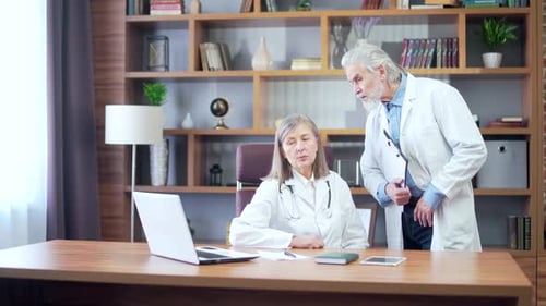 Doctors Discussing Medical Data in an Office
