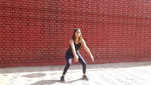 Video of sporty girl performing jump squat exercise.
