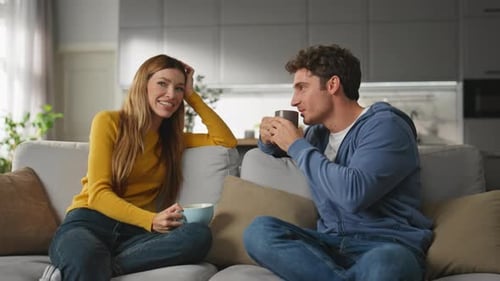 Friends Talking and Drinking Coffee Together Indoors