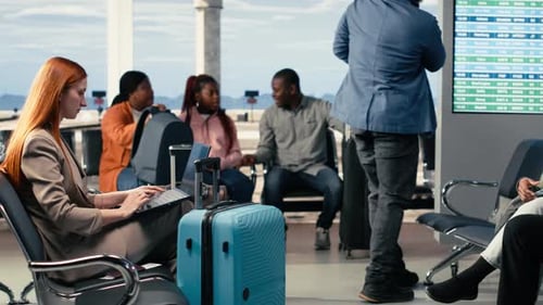 Diverse Crowd of Travelers Relaxing in Bright Airport Lounge Near Departure Gate